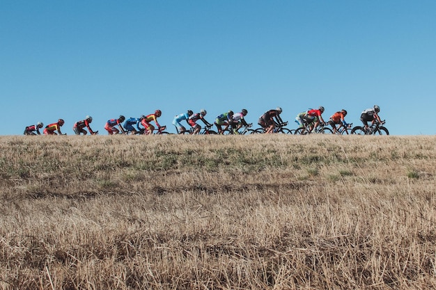 Ciclisti che si esibiscono durante una gara sportiva contro un cielo blu limpido
