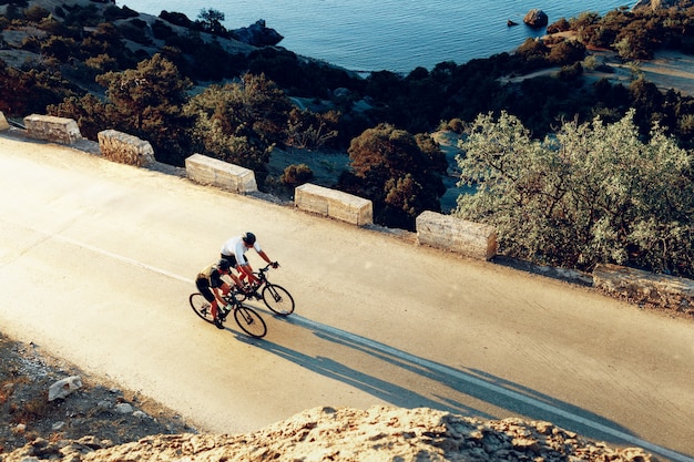 Ciclisti maschi professionisti in sella alle loro biciclette da corsa