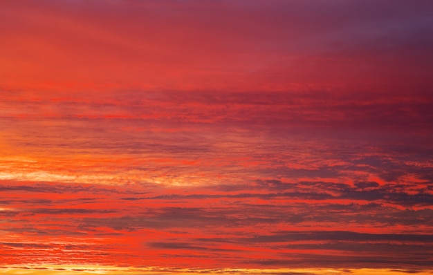 Cielo di tramonto di colori arancioni, rossi e gialli luminosi. Sfondo del cielo al tramonto apocalittico