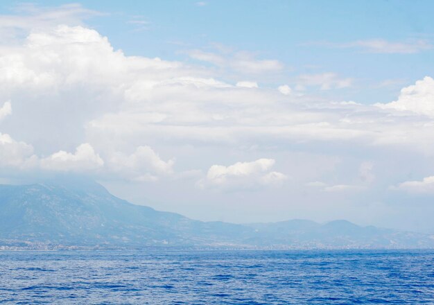 cielo nuvoloso blu lasciando per orizzonte sopra una superficie blu del mare