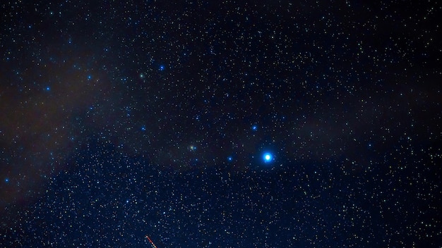 Cielo stellato con costellazioni brillanti e stelle cadenti di notte. Timelapse del cielo stellato con nuvole, nebulose e galassie