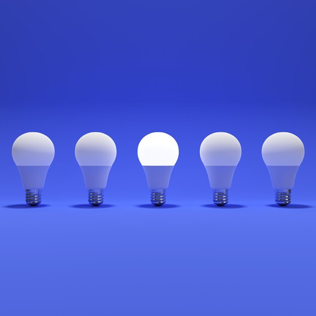 Cinque lampadine e una lampadina luminosa con sfondo blu