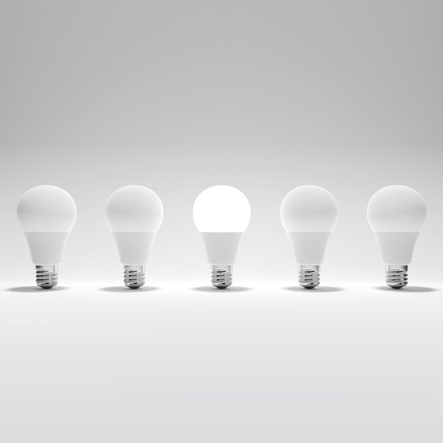 Cinque lampadine e una lampadina luminosa su sfondo bianco
