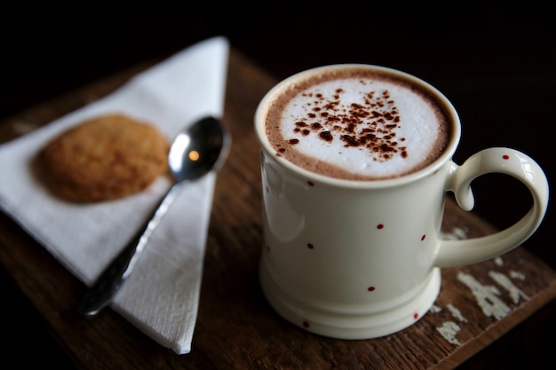 Cioccolata calda con biscotti a bordo di legno