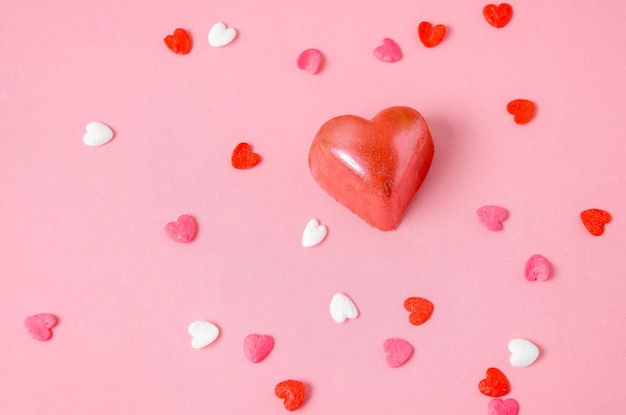 Cioccolatini a forma di cuori rosa Sfondo rosa chiaro