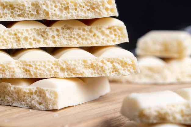 Cioccolato bianco poroso su un tavolo di legno