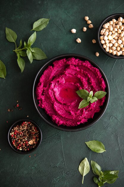 Ciotola dell'humus. Hummus di barbabietola rossa con verdure fresche, olio d'oliva in tavola