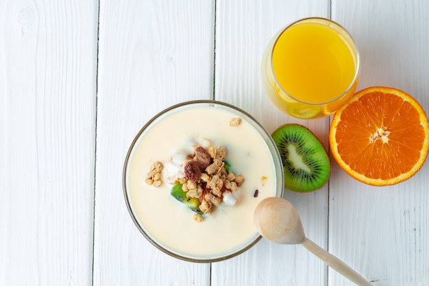 Ciotola di muesli con youghurt e frutta affettata