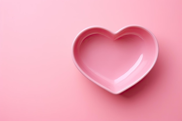 Ciotola in ceramica rosa a forma di cuore su sfondo rosa Vista dall'alto Spazio di copia Biglietto di San Valentino