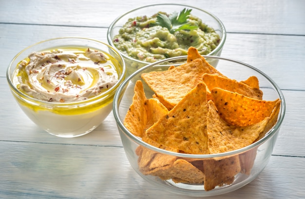 Ciotole di hummus e guacamole con tortilla chips