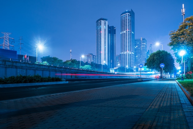 Città, edifici moderni e strade, automobili in esecuzione