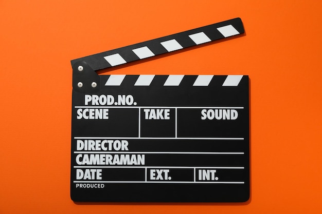 Clapperboard per le riprese su sfondo arancione vista dall'alto