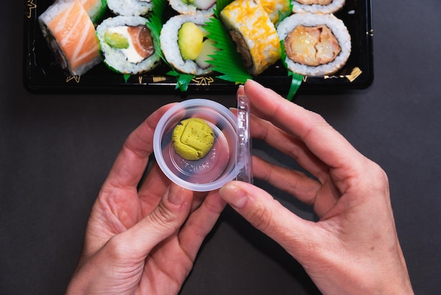 Close de manos con wasabi per mangiare sano con sushi