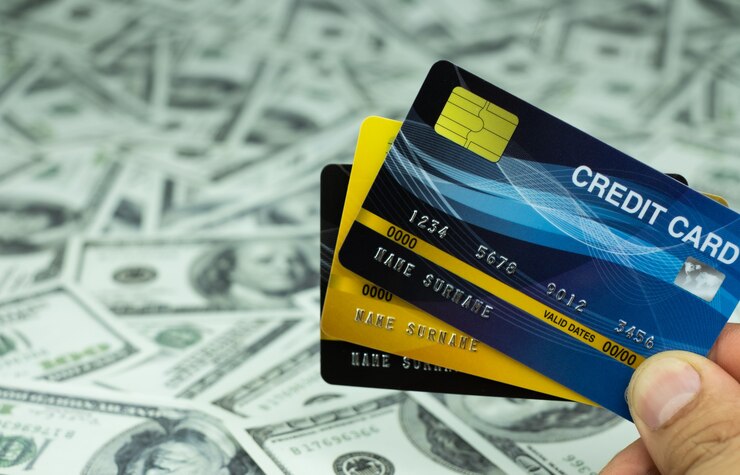 Photo close up credit card isolated at the stack of money banknote 100 usd background