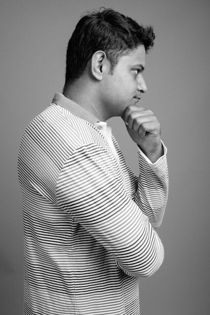 Close up del giovane indiano uomo che indossa manica lunga a righe polo shirt