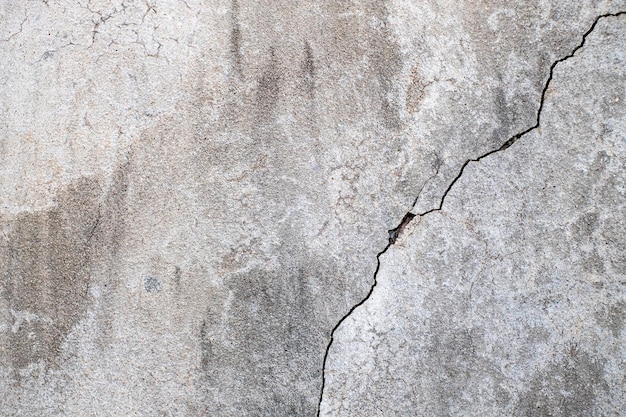Close-up della consistenza della parete di cemento rotta sullo sfondo del cemento non dipinto in stile vintage per la grafica