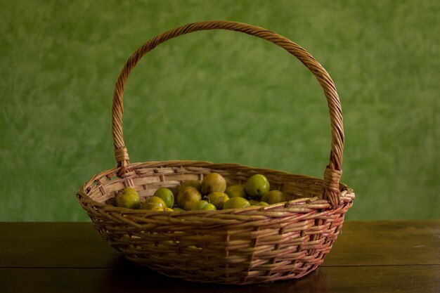 Close-up di frutta in cesto su tavolo contro la parete