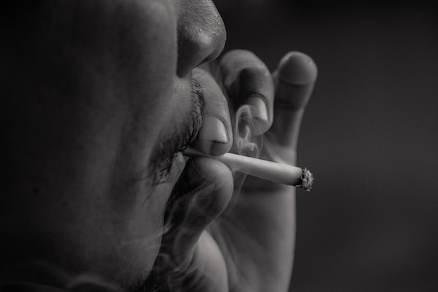 Close-up di un uomo che fuma una sigaretta