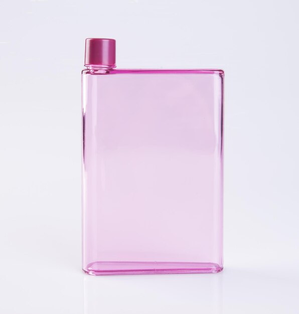 Close-up di una bottiglia rosa su sfondo bianco