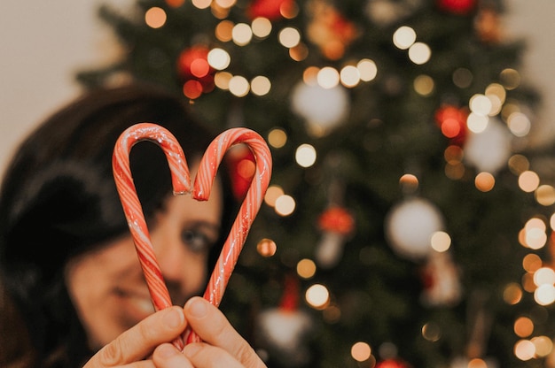 Close-up di una mano che tiene un albero di Natale illuminato