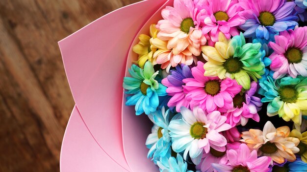 Close up fiore arcobaleno fiori bouquet luminoso su sfondo di legno