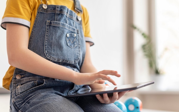 Close up kid holding tablet