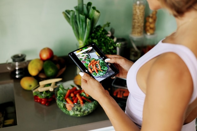 Close-up of a girls hand taking a photo on her phone a young woman a culinary blogger
