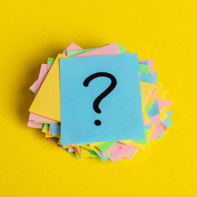 Close-up of adhesive notes on yellow table