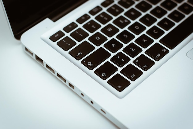 Close-up of cropped laptop on table
