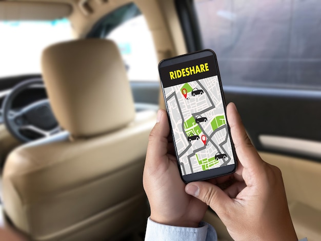 close-up of person using mobile phone while car pooling