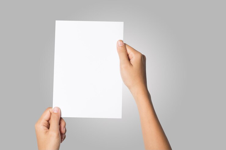 Close Up of woman hand holding blank paper isolated on white background