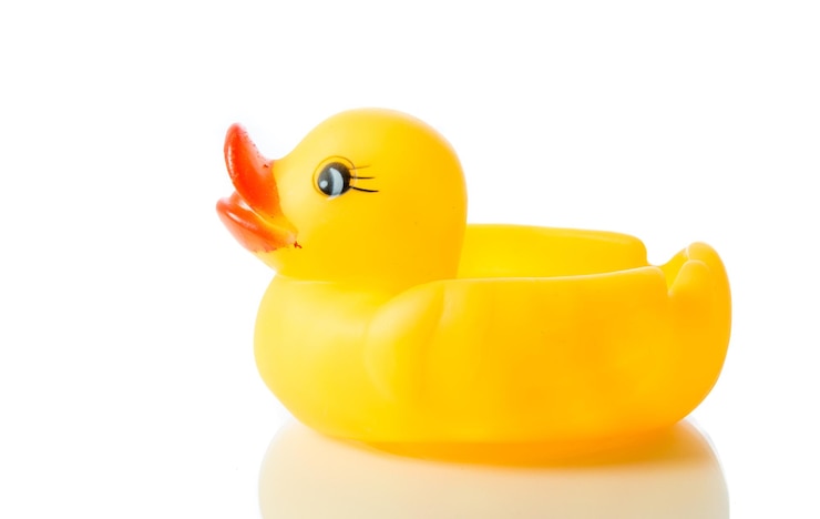 Photo close-up of yellow toys against white background