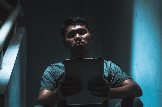 Close-up of young man using digital tablet