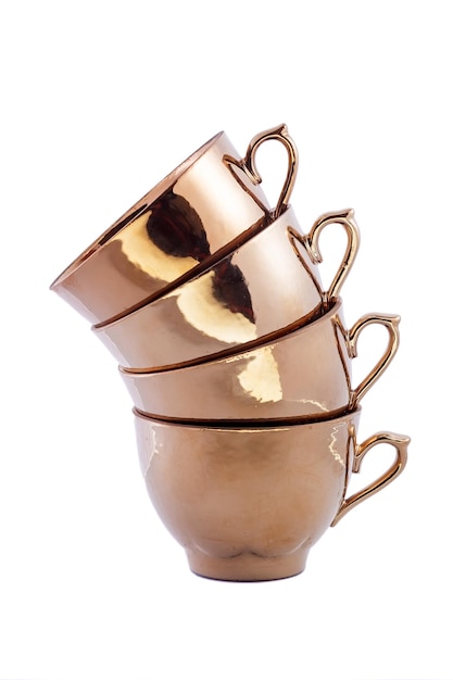 Close-up set di belle tazze da tè in porcellana vintage oro cobalto su sfondo bianco. Copia spazio.