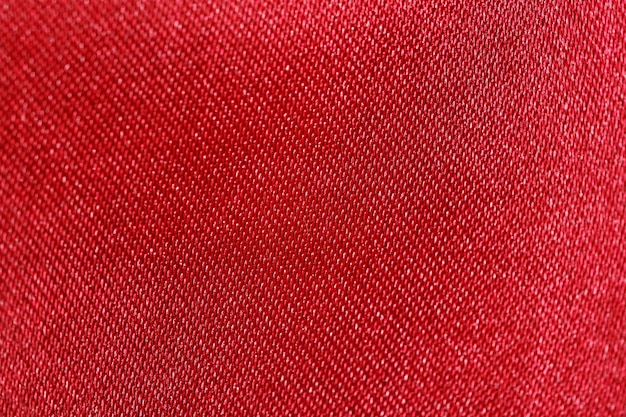 Close-up Texture di tessuto di poliestere rosso con lucentezza Sfondio per il tuo disegno Materiali per la cucitura