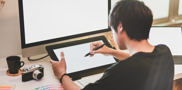Photo close-up view of motivated photographer drawing on tablet