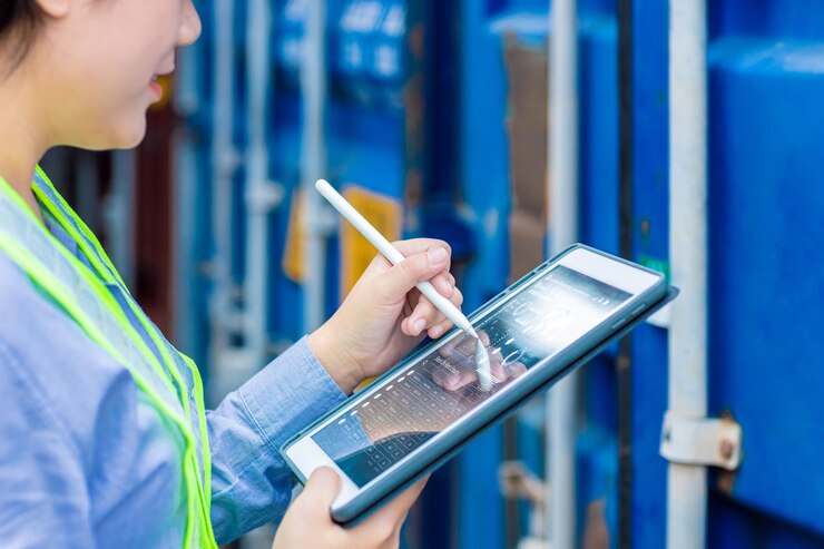 Closeup Logistic Worker industry using Online Tablet Technology Application Tracking Cargo Container World Wide Management