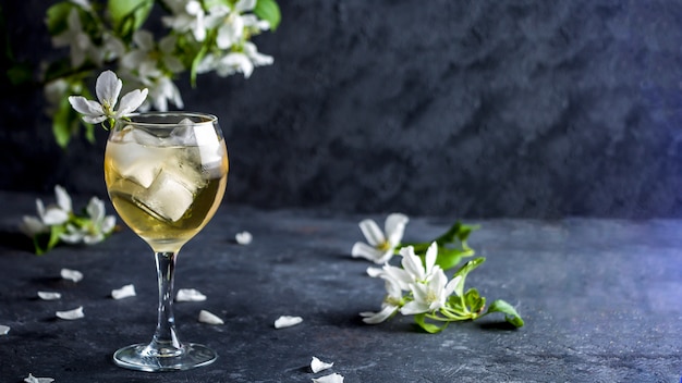 Cocktail alcolico di mela con spumante in vetro con fiori