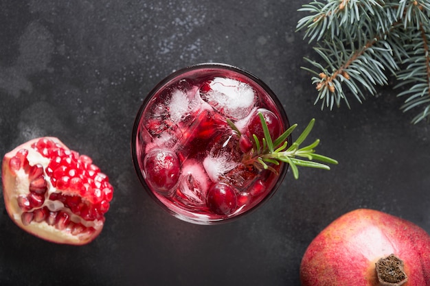 Cocktail di natale del melograno con rosmarino, champagne, soda del club sul nero. Vista dall'alto