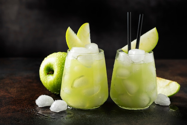 Cocktail estivo con mela verde e ghiaccio. Immagine di messa a fuoco selettiva con copia spazio