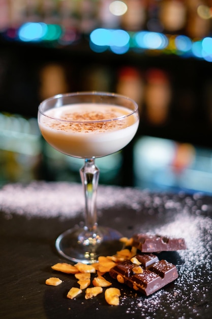 Cocktail guarnito con cioccolato secco sul bancone del bar Il concetto della corretta preparazione delle bevande