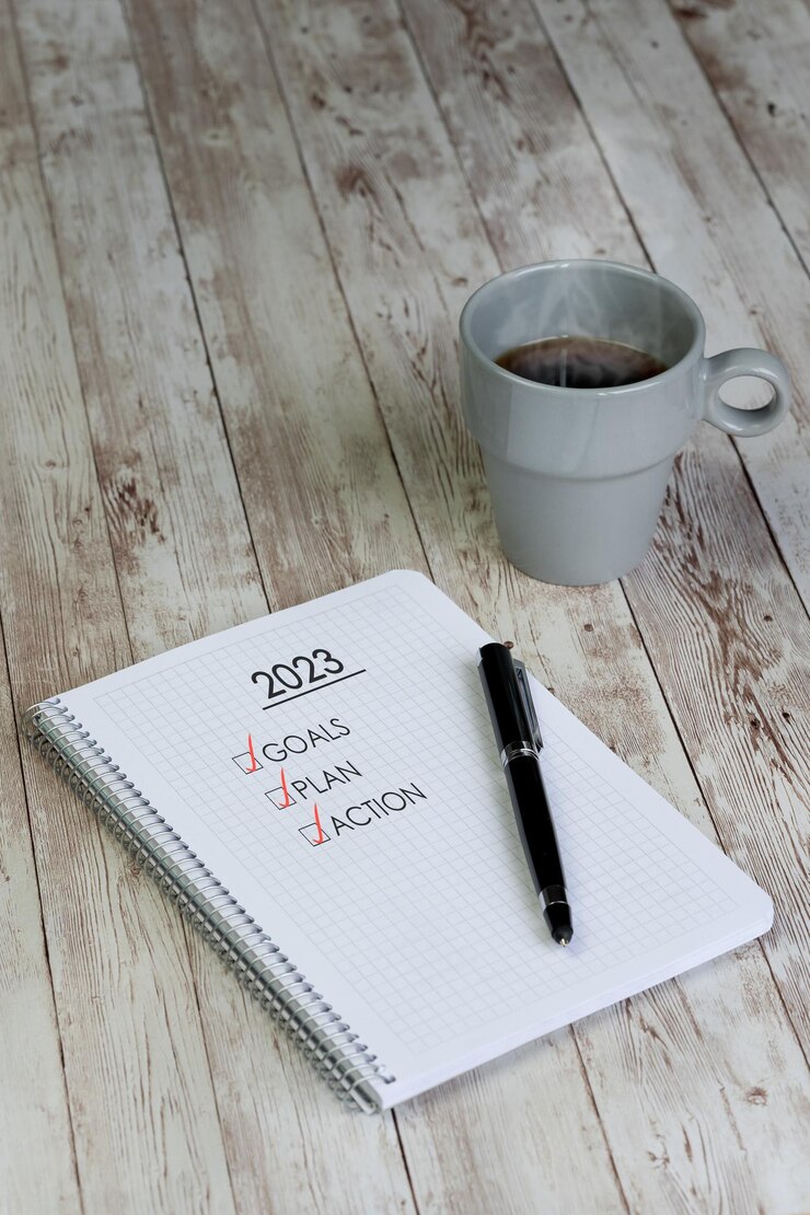 Photo coffee and notebook with a todo list for the year 2023 concept goals and action plan new year