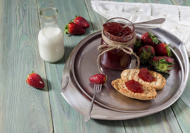 Colazione a base di marmellata di fragole su fette biscottate