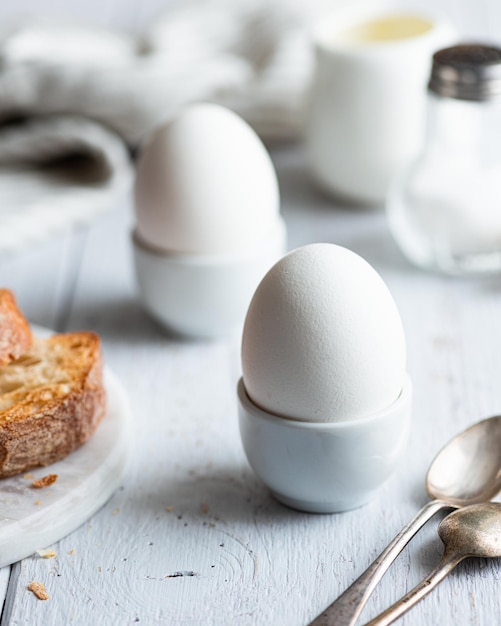 Colazione di uova alla coque su uno sfondo bianco fuoco selettivo