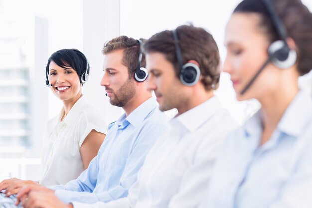 Colleghi di lavoro con auricolari di fila