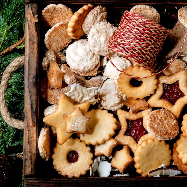 Collezione di biscotti di pasta frolla fatta in casa di Natale sui rami di thuja. Vista dall'alto