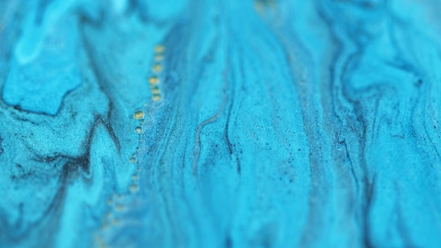 Colore fluido luccicante flusso di vernice sfocato neon blu luccicante gocciolante fluido siero miscela particelle di bolle acqua