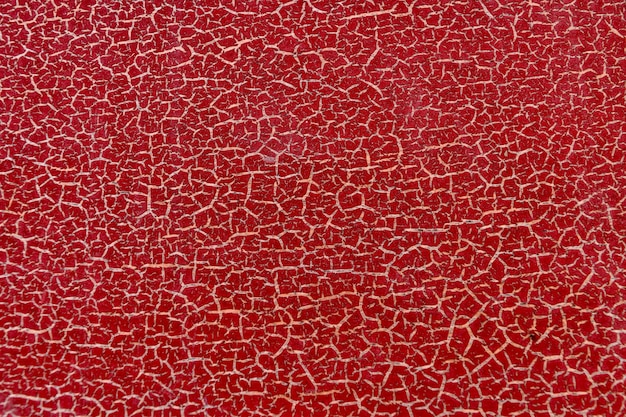 Colore rosso incrinato trama o sfondo, il vecchio muro rosso Piccole crepe.