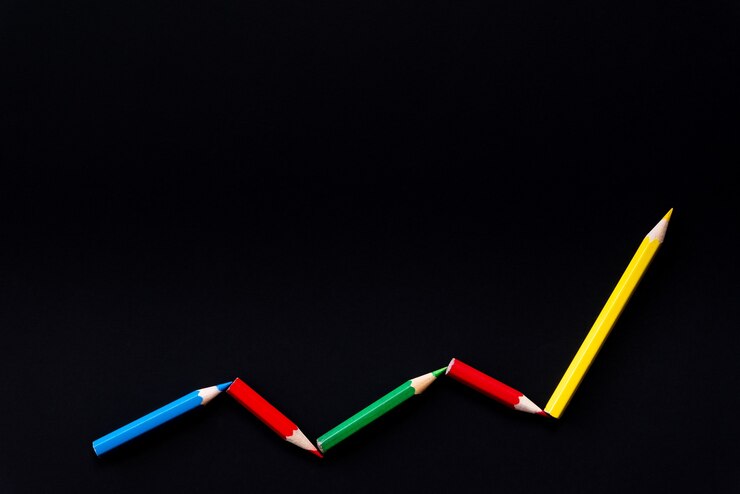 Foto colori la matita in un modello di un grafico sul fondo nero di colore con lo spazio della copia