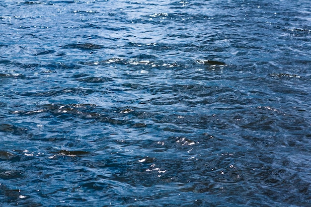 Colpo di sfondo della superficie dell'acqua di mare aqua